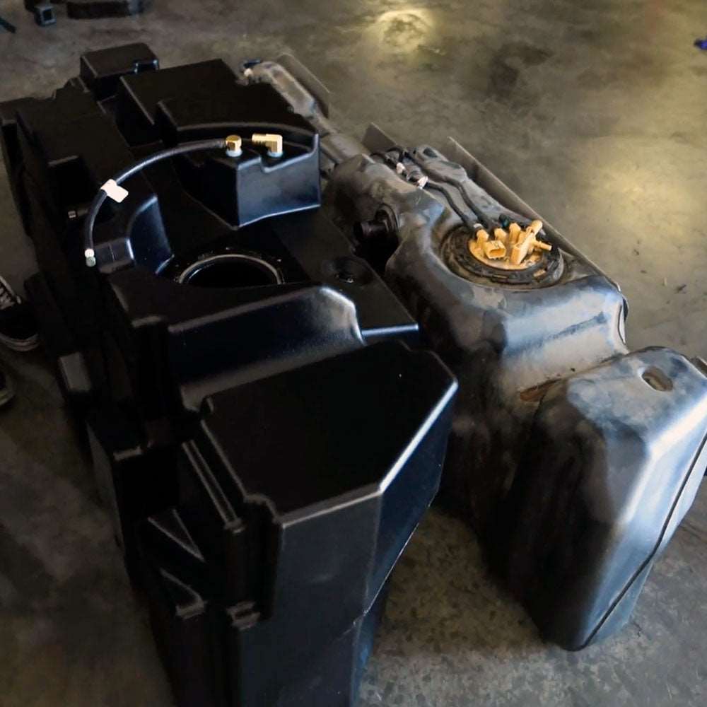 The 62-gallon aftermarket fuel tank for GM Duramax beside a vehicle for scale