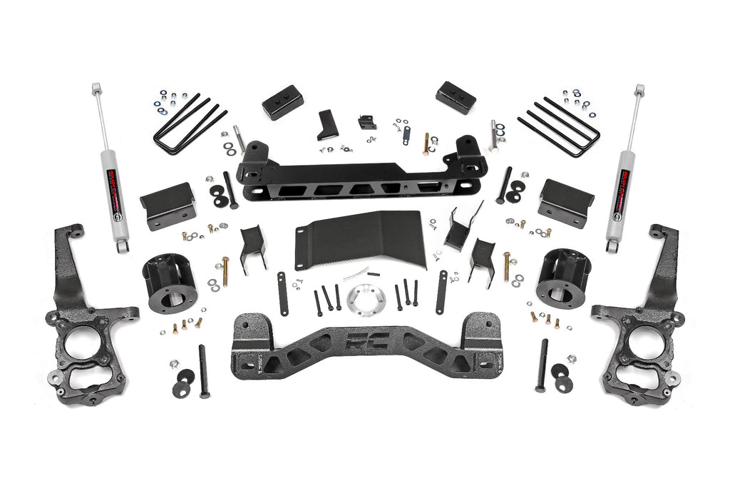 Components of the 4-inch lift kit for Ford F-150 4WD, including front and rear suspension parts