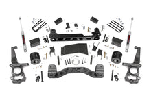 Load image into Gallery viewer, Components of the 4-inch lift kit for Ford F-150 4WD, including front and rear suspension parts