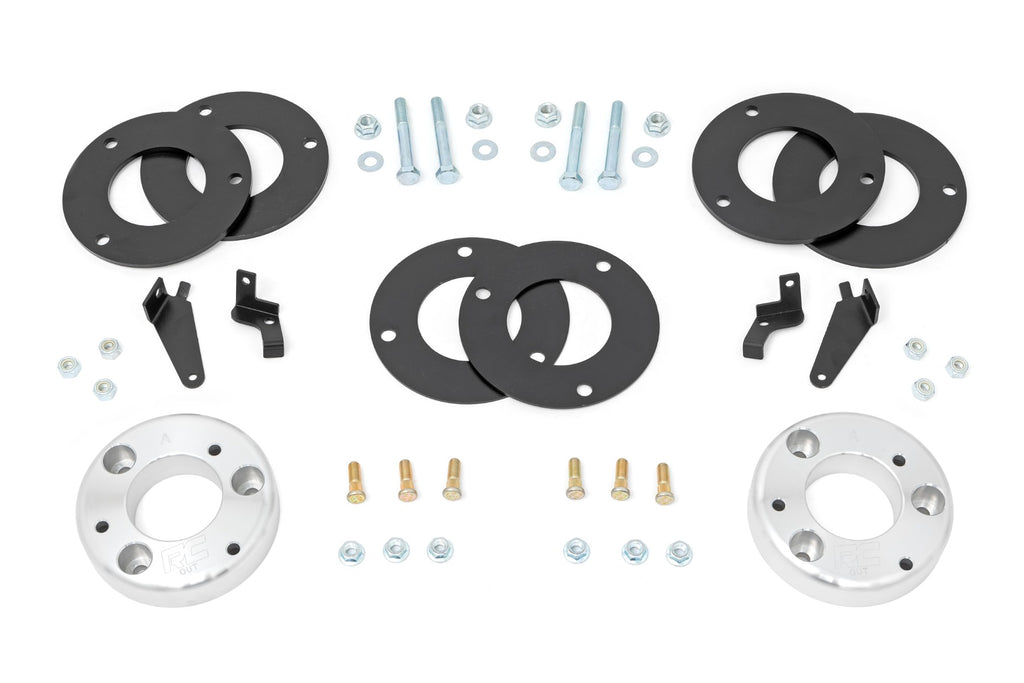 Components of a 2-inch lift kit for a Ford Expedition, including aluminum spacers and installation hardware