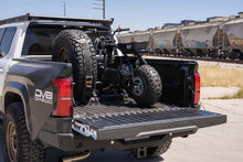 Load image into Gallery viewer, DV8 Offroad Truck Bed Universal Tire Carrier &amp; Accessory Mount