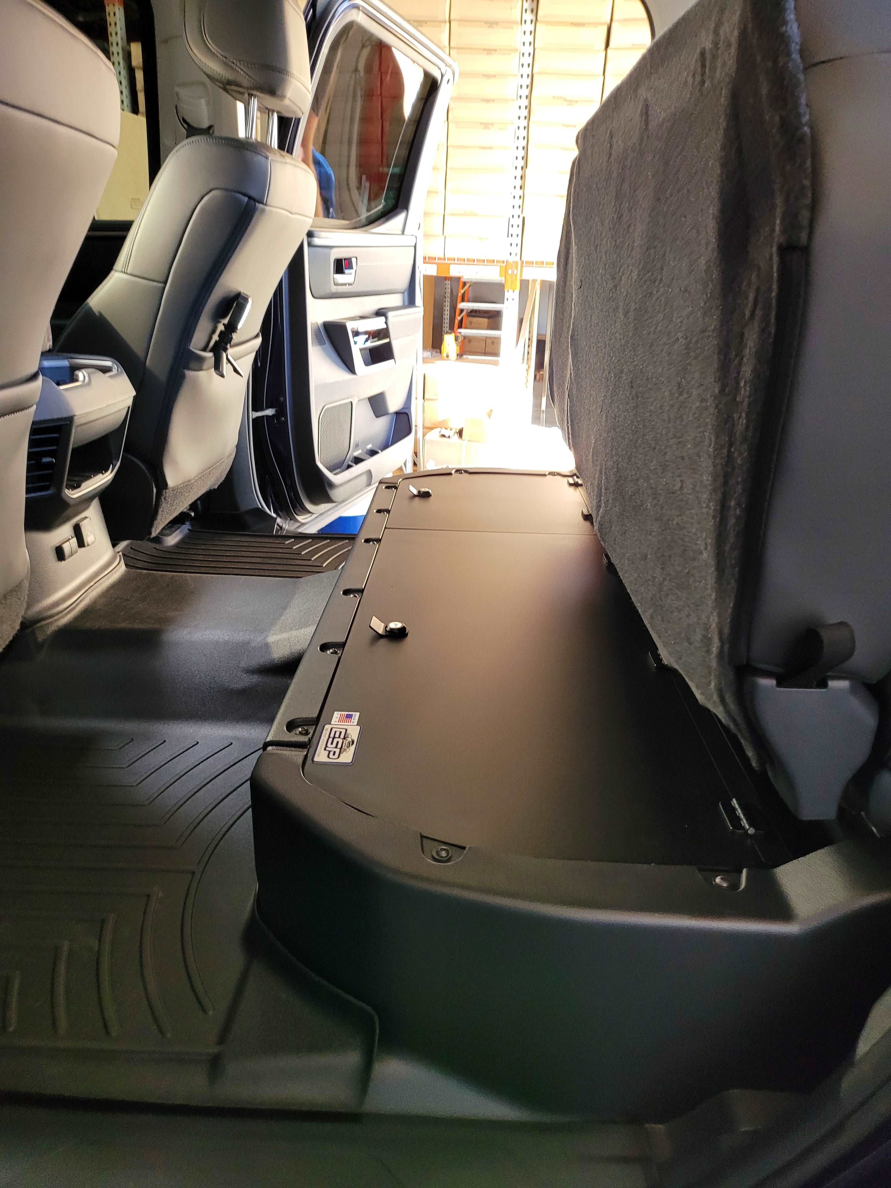 Under-seat lockable storage compartment installed in a 2022-2024 Toyota Tundra CrewMax