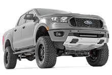 Load image into Gallery viewer, Close-up of a Ford Ranger 4WD with a 6-inch Rough Country lift kit installed