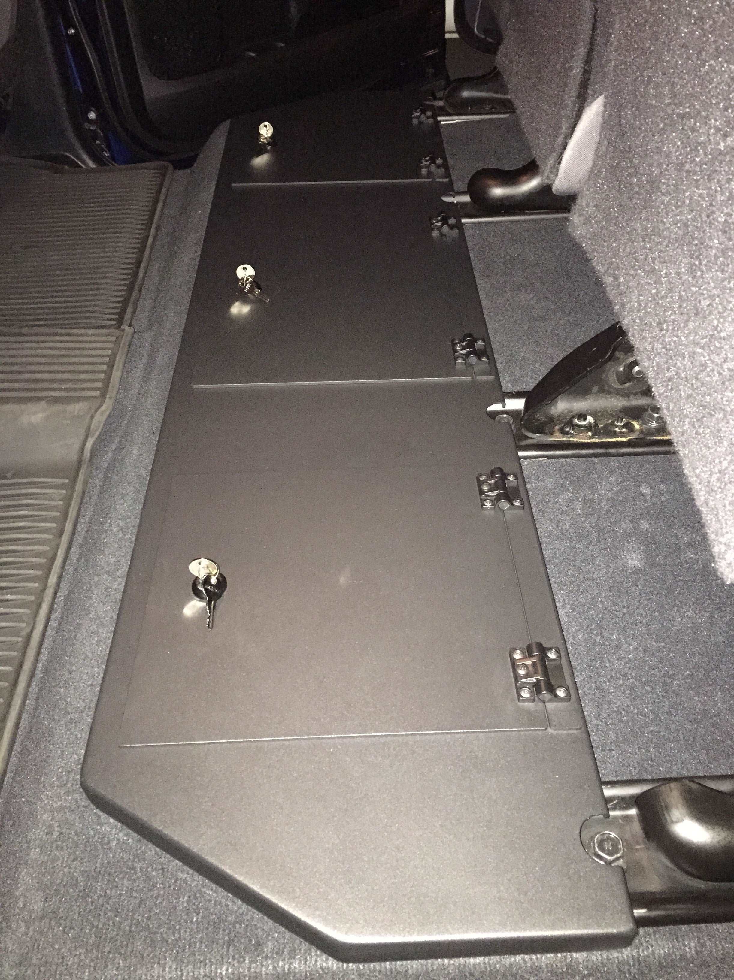 Under-seat area of a Toyota Tundra CrewMax equipped with dual metal lockable storage boxes