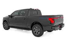 Load image into Gallery viewer, Rear view of a Ford F-150 Lightning equipped with a 3/4 inch Rough Country leveling kit