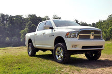 Load image into Gallery viewer, Ram 1500 4WD &amp; Classic equipped with a 4-inch Rough Country lift kit, displayed outdoors