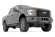 Load image into Gallery viewer, Ford F-150 equipped with a 4-inch Rough Country lift kit showcasing the elevated stance