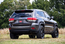Load image into Gallery viewer, Jeep Grand Cherokee equipped with a 2.5-inch N3 strut lift kit on an off-road terrain