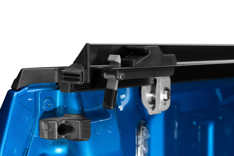Close-up of the blue truck's tailgate featuring a secure locking mechanism