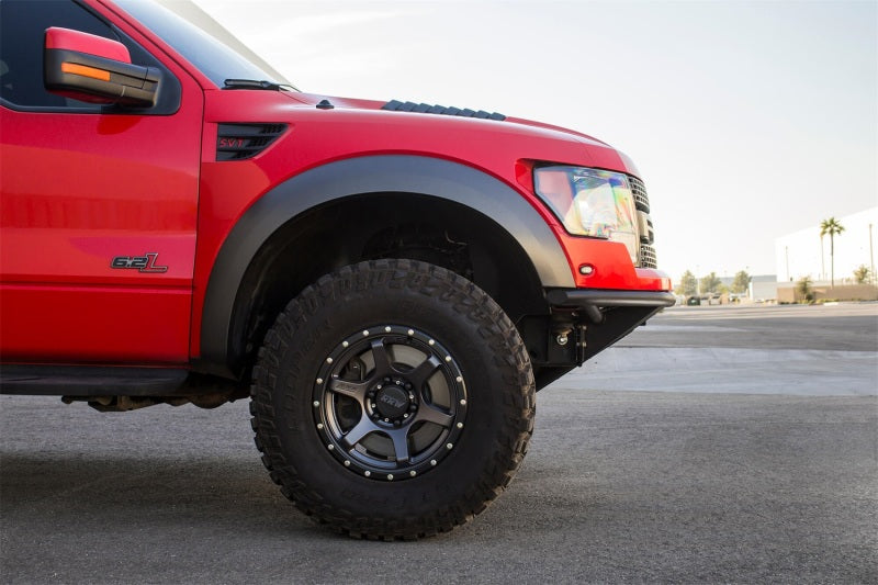 Red Ford F-150 Raptor showcasing its off-road tires and ADD PRO bumper