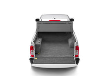 Load image into Gallery viewer, Rear view of a white Nissan Frontier with a BedRug bedliner installed