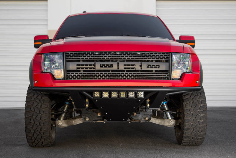 Detailed image of the ADD PRO bumper on a red Ford F-150 Raptor