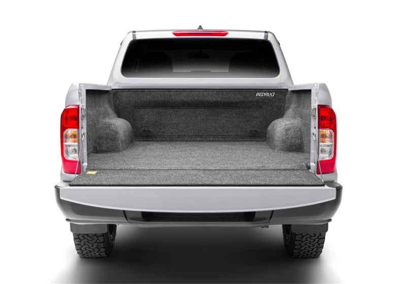 Gray BedRug bedliner fitted in the back of a Nissan truck