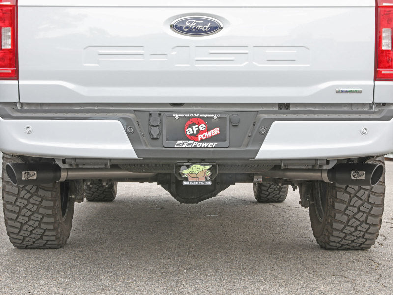 Installation view of aFe Vulcan exhaust on a white Ford F-150's rear