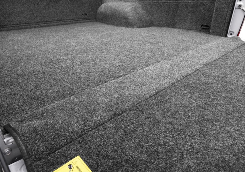 Close-up of the BedRug liner with a yellow label inside a truck bed