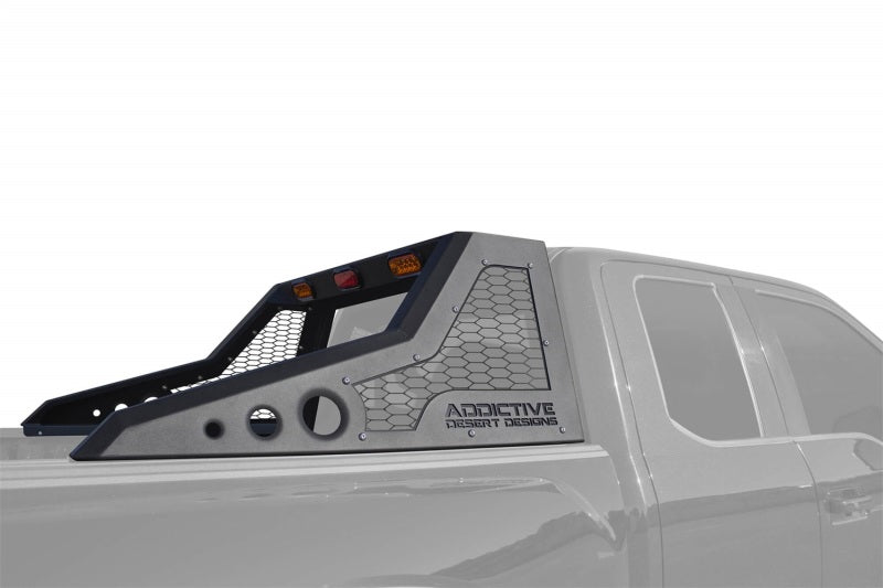 Rear view of a Ford F-150 Raptor with an Addictive Desert Designs HoneyBadger Chase Rack installed