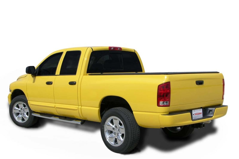 Side profile of a yellow Dodge Ram 1500 with Access Vanish cover against a white backdrop