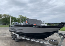 Load image into Gallery viewer, Boat with Truxedo Boat Windshield Protector mounted on a trailer in a parking area
