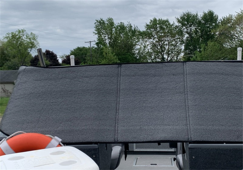 Boat equipped with Truxedo Boat Windshield Protector and a cooler beside it