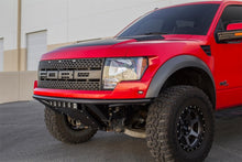 Load image into Gallery viewer, Red Ford F-150 Raptor with ADD PRO bumper parked outside a building