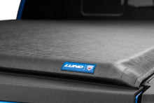 Load image into Gallery viewer, Textured black fabric of the Lund Genesis Roll Up Tonneau Cover with blue logo detail